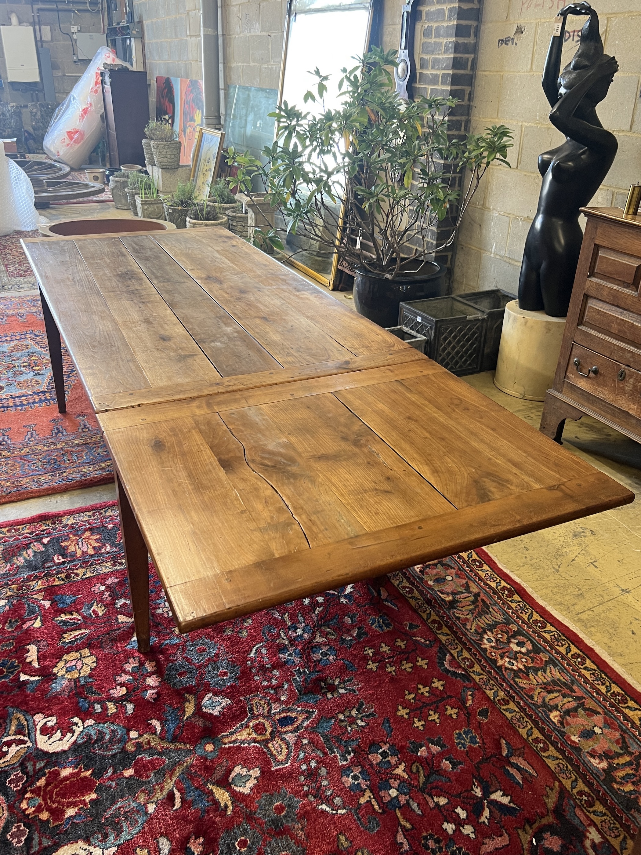 A 19th century French cherry farmhouse table with single extension on square tapered legs, width 166cm, (232cm extended) depth 82cm, height 73cm